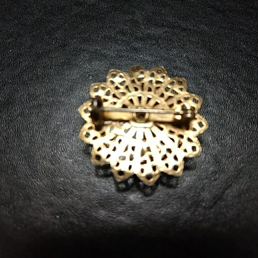 Gold tone flower pin with pink stones brooch